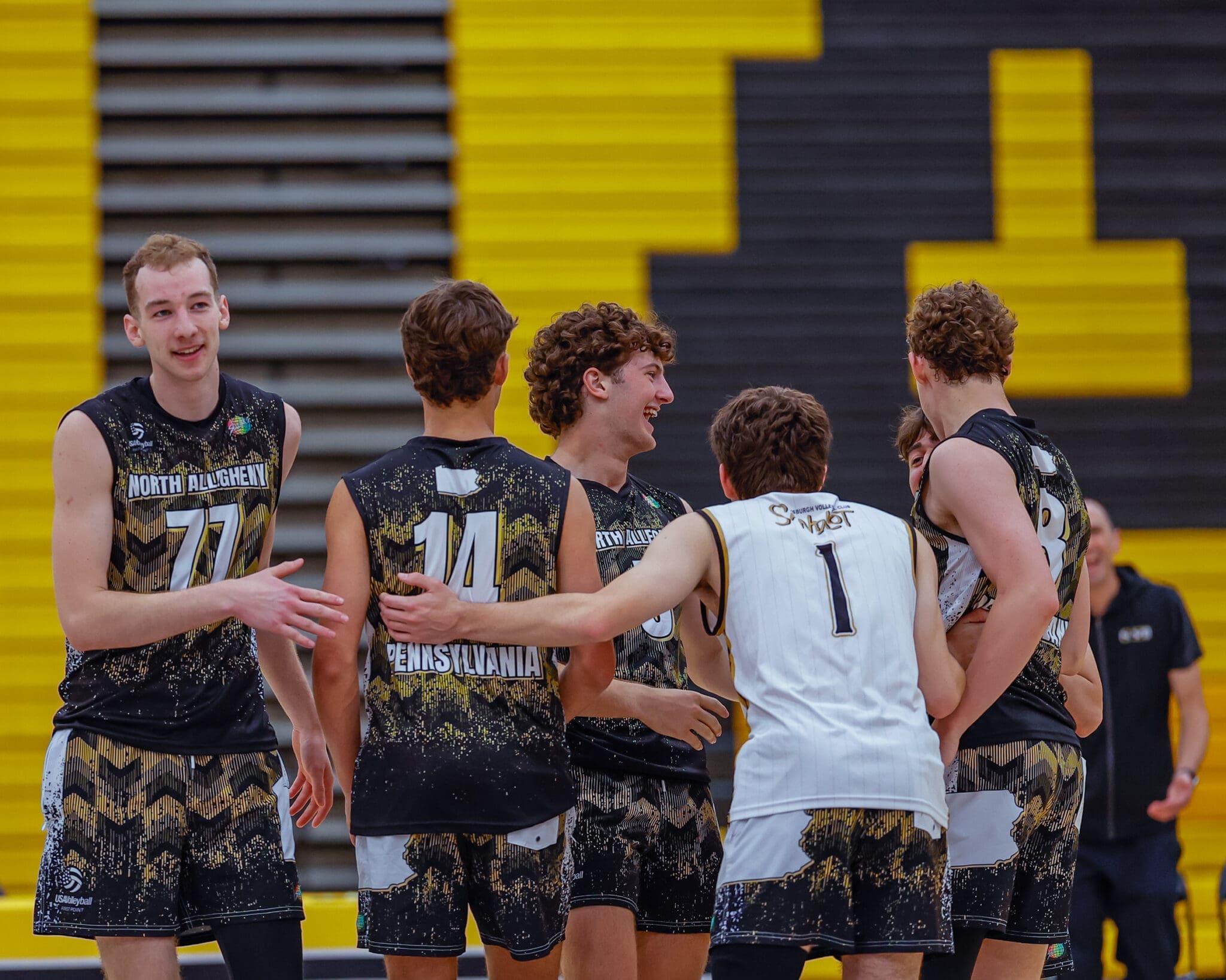 North Allegheny high school volleyball team celebrating a point, featuring players in jerseys against a vibrant backdrop.