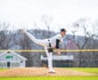 Baseball pitcher preparing to throw on the mound, showcasing athletic form and focus during a game.