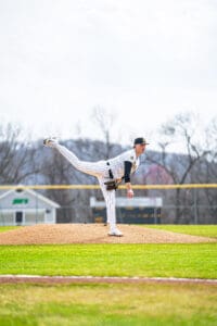 Baseball pitcher preparing to throw on the mound, showcasing athletic form and focus during a game.