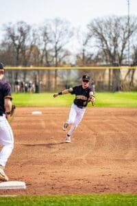 A baseball player from the Tigers team makes a dynamic throw during a game on a sunny day.