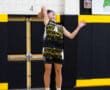 A young male volleyball player jumps to spike the ball during a game, showcasing athleticism and team spirit.