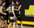 North Allegheny volleyball players celebrate a victory, showcasing teamwork and excitement on the court.