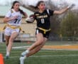 A dynamic flag football play, showcasing two female athletes in action on the field during a game.
