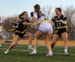 High school girls playing flag football, showcasing teamwork and athleticism on the field during a competitive match.