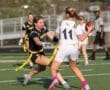 A dynamic moment in a flag football game, showcasing intense competition and athleticism among female players.