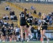 Cheering players celebrate a touchdown during a flag football game, showcasing teamwork and school spirit on the field.