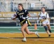 Female flag football player in action, running with the ball during a game, showcasing athleticism and team spirit.