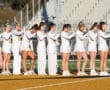 Lacrosse team stands in formation on the field, ready for the game, showcasing teamwork and athletic spirit.