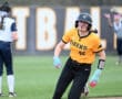Student-athlete in a Tigers softball uniform runs the bases during a game, showcasing determination and athleticism.