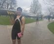 Rower carrying a boat on a pathway, showcasing athletic gear and teamwork in a scenic outdoor setting.