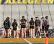 Cheerful flag football players and coaches meet referees at the field before a game, showcasing teamwork and sportsmanship.