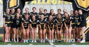 Cheerful team photo of the Tigers flag football squad, showcasing players in black uniforms at their home field.