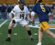 High school lacrosse players face off on the field, showcasing athleticism and competitive spirit during a game.
