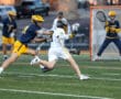 Lacrosse players compete fiercely on the field, showcasing skill and teamwork during an intense match.