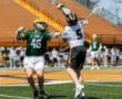 St. Edward's lacrosse player (#46) defends as opposing player (#5) attempts a shot during an intense game.