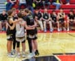 Team huddles together during a basketball game for strategy and motivation on the court.