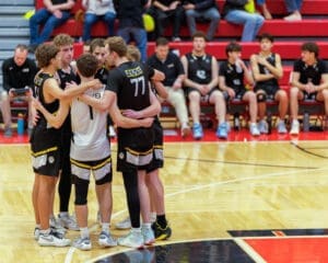 Team huddles together during a basketball game for strategy and motivation on the court.