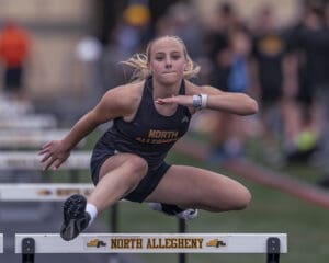 Young athlete hurdles during a track event for North Allegheny, showcasing determination and athleticism.