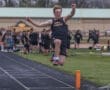 High school athlete from North Allegheny competing in long jump, showcasing athleticism on the track.