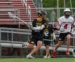 High school lacrosse players compete on the field, showcasing athleticism and teamwork in an exciting match.