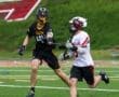 Lacrosse players compete on the field, showcasing athleticism and teamwork during a dynamic match.