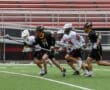 High school lacrosse players sprint across the field, competing fiercely during a game.