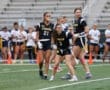 Girls' flag football team in action, showcasing teamwork and competitive spirit on the field.