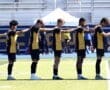 Soccer team lined up for a warm-up on the field, showcasing team spirit and athleticism before the match.