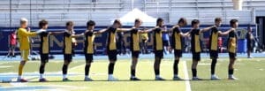 Soccer team lined up for a warm-up on the field, showcasing team spirit and athleticism before the match.