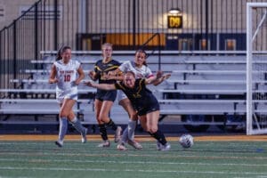 Girls' high school soccer match in action, featuring players from Fox Chapel and other teams battling for the ball.