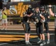 Players celebrating a touchdown on the field, showcasing teamwork and excitement in a high school football game.