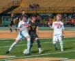 High school soccer players in action, competing fiercely on the field during a vibrant match.