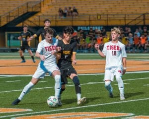 High school soccer players in action, competing fiercely on the field during a vibrant match.