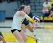 Player successfully receives a volleyball during a competitive match, showcasing athleticism and teamwork on the court.