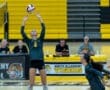 Volleyball player sets the ball in action during a game at North Allegheny High School, with teammates and announcers visible.