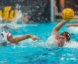 Water polo players compete in a dynamic match, showcasing skill and agility in a splash-filled pool.
