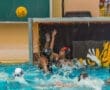 Water polo players compete fiercely as a ball soars toward the goal, splashes from the water all around.