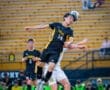 High school soccer players compete for the ball in an action-packed game, showcasing skill and teamwork.