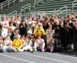 North Allegheny soccer team poses together in celebration, showcasing teamwork and school spirit under stadium lights.