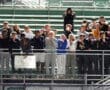 Group of students posing with playful expressions in a stadium, showcasing team spirit and camaraderie.