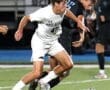 North Allegheny soccer player dribbles the ball during a competitive high school match against an opposing team.