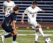 North Allegheny soccer players compete on the field during a night game, showcasing athleticism and teamwork.