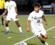 North Allegheny soccer players in action on the field during a night game, showcasing teamwork and agility.