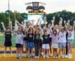 Cheerleading team of girls celebrating at Wright Field, North Allegheny, with hands raised in excitement.