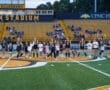 Girls' soccer team celebrates with young fans at North Allegheny Stadium, showcasing community spirit and teamwork.